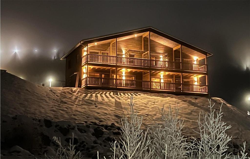a wooden house on top of a hill at night at 4 Bedroom Beautiful Home In Sysslebck in Sysslebäck