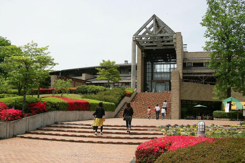 a group of people walking down stairs in front of a building at Greenpia Yame in Yame