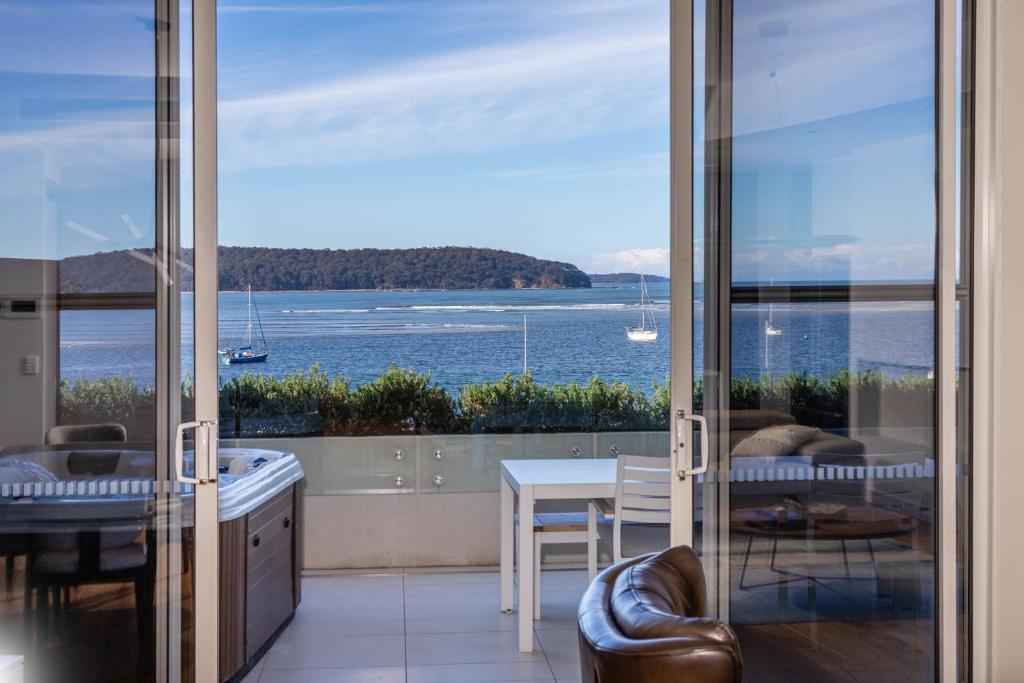 a living room with a view of the ocean at Penthouse On The Promenade in Batemans Bay