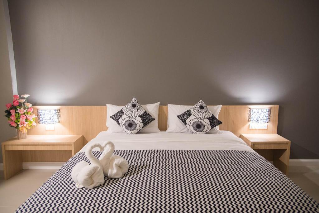 a bedroom with a bed with two stuffed animals on it at It's me Keawanong Hotel in Nakhon Ratchasima