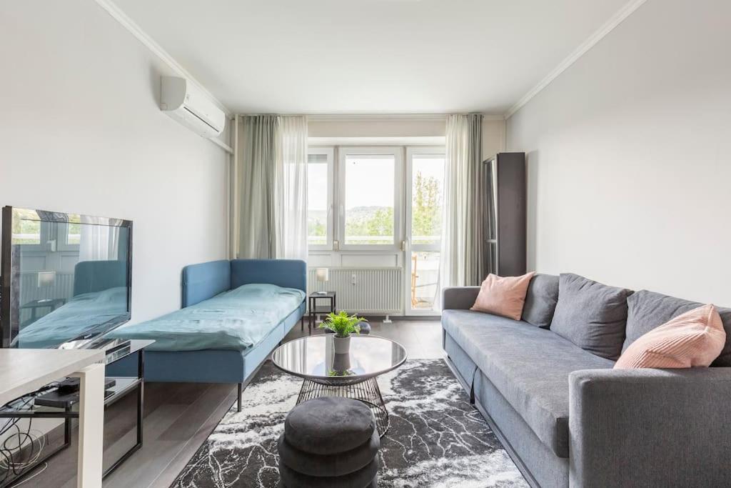 a living room with a couch and a table at Lovely 1 Bedroom Flat - Gazdagrét in Budapest