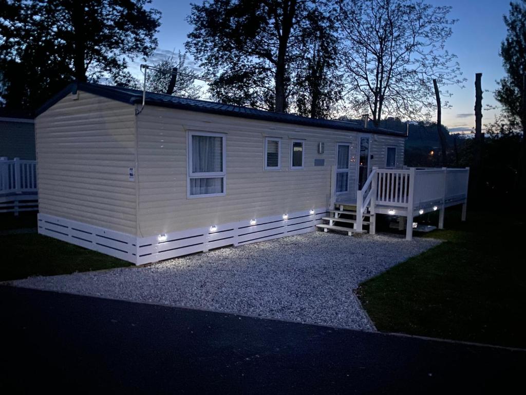 a small white house with lights on it at Golden sands holiday park- pitch H84 in Cockwood