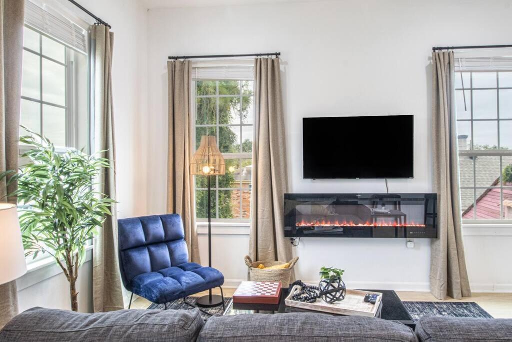a living room with a couch and a fire place at Upscale Loft Downtown NOLA 2835 in New Orleans