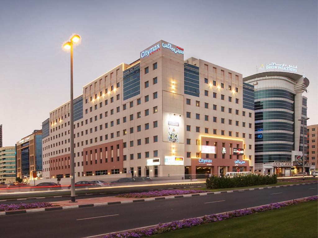 a large building on a street in a city at Citymax Hotel Bur Dubai in Dubai