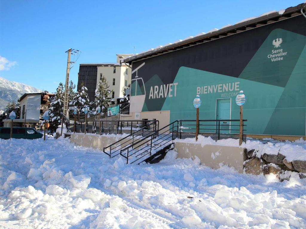 a building with a pile of snow in front of it at Appartement Serre Chevalier, 1 pièce, 4 personnes - FR-1-330F-119 in Serre Chevalier