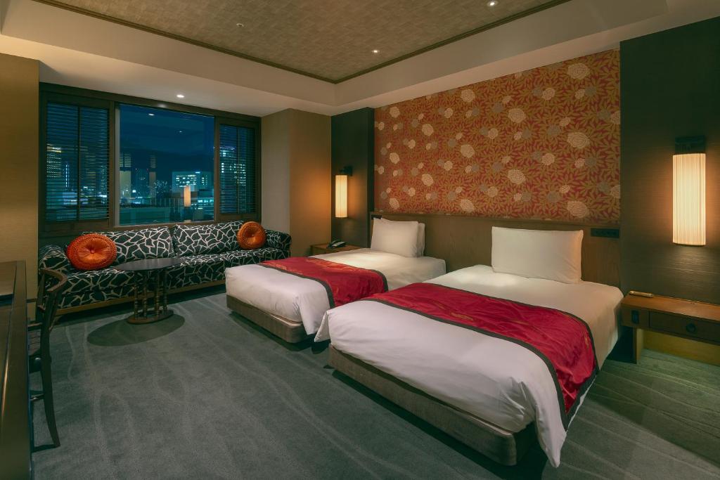 Postel nebo postele na pokoji v ubytování ORIENTAL HOTEL