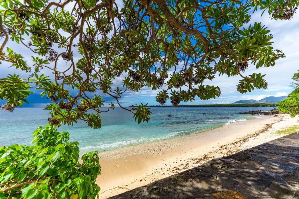 a view of a beach with the ocean at Beachfront Tamarin Villa in Tamarin