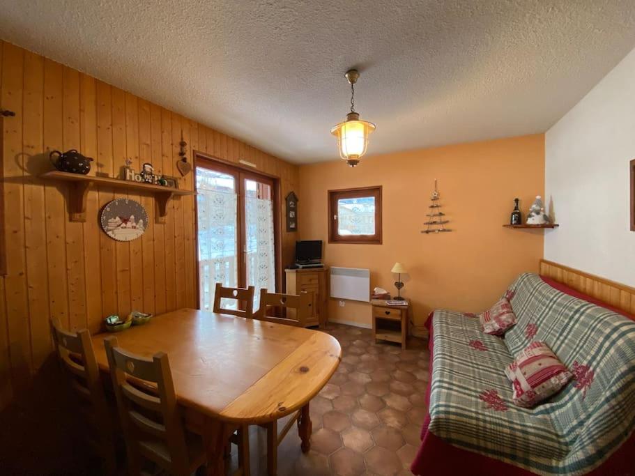 a living room with a table and a couch at Appartement ensoleillé Lanslevillard station Val Cenis Vanoise in Lanslevillard