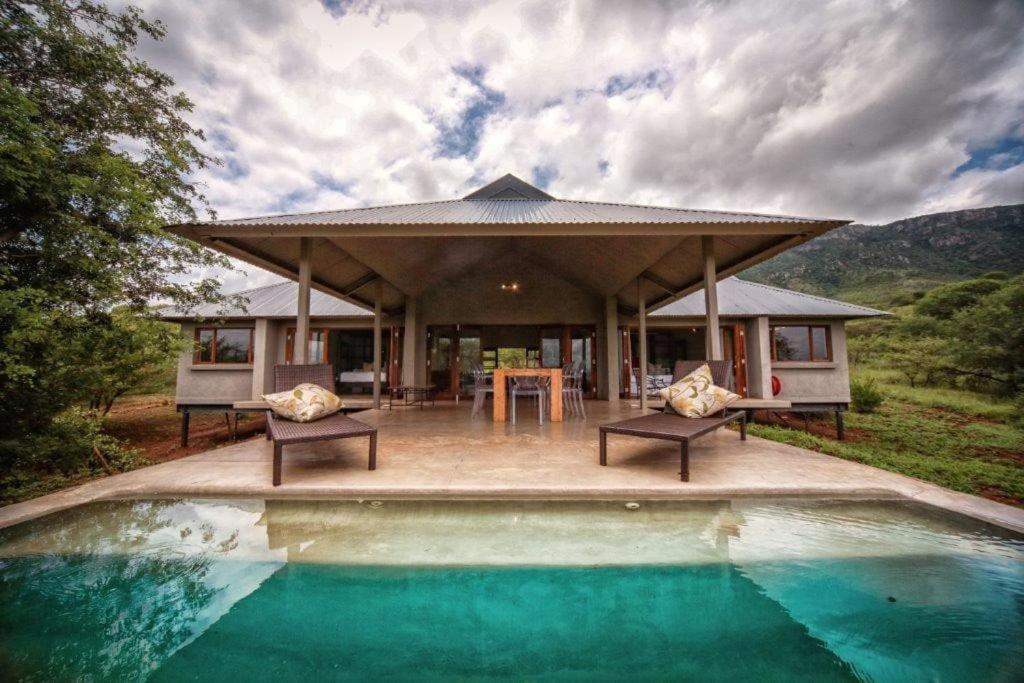 a house with a pool in front of it at Bushwillow Lodge, Royal Jozini PGR, eSwatini in Lavumisa