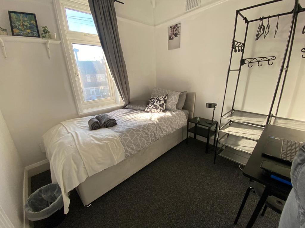 a small bedroom with a bed and a window at Peaceful stay Derby Single Room in Derby