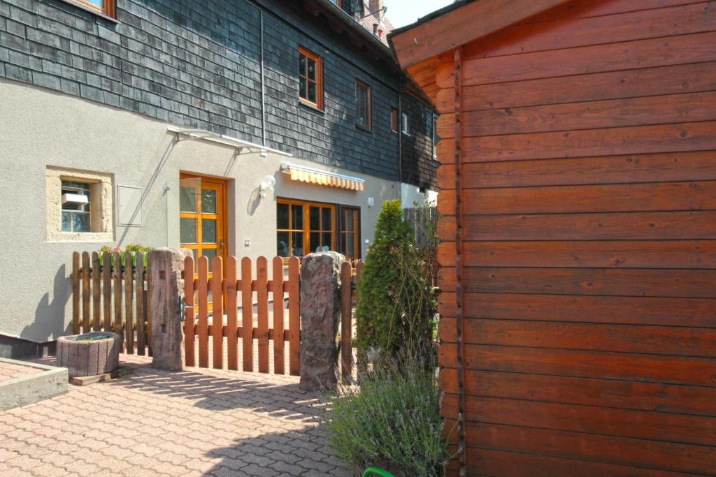 a wooden fence in front of a house at Ferienwohnung Harmonie in Bad Teinach-Zavelstein