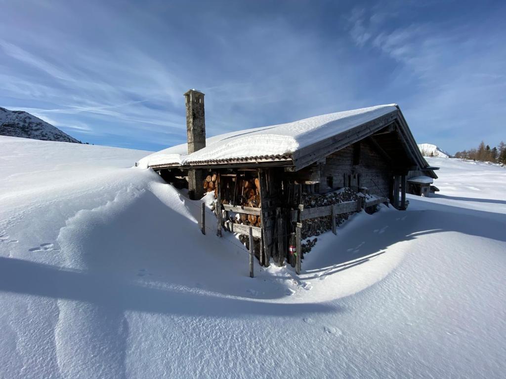 un edificio cubierto de nieve en la nieve en Das Landhaus am See en Achenkirch