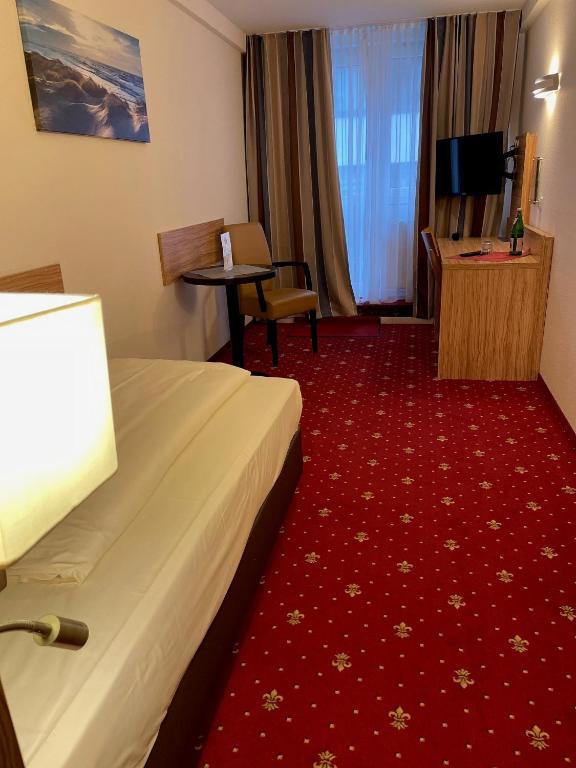 TV a/nebo společenská místnost v ubytování Hotel Harburger Hof