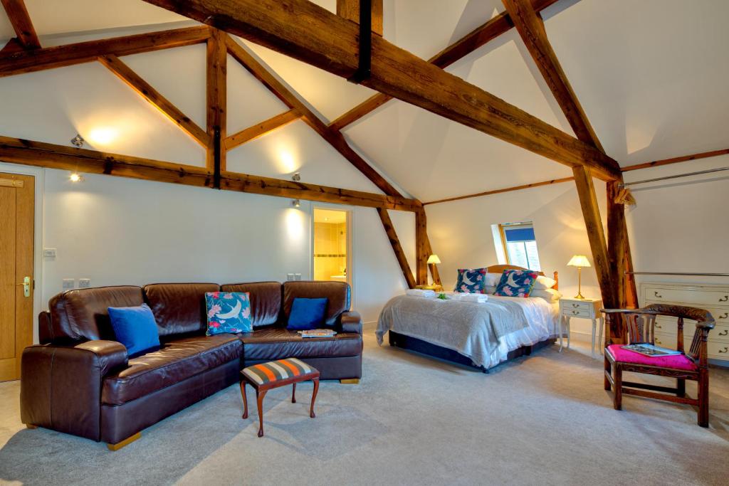 a bedroom with a couch and a bed in a room at Luxury Studio Suite in Stamford Centre - The Old Seed Mill - B in Stamford