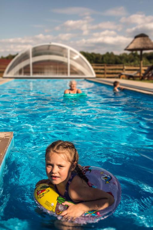 a little girl in a swimming pool in a raft at Górski Ogród in Łagów