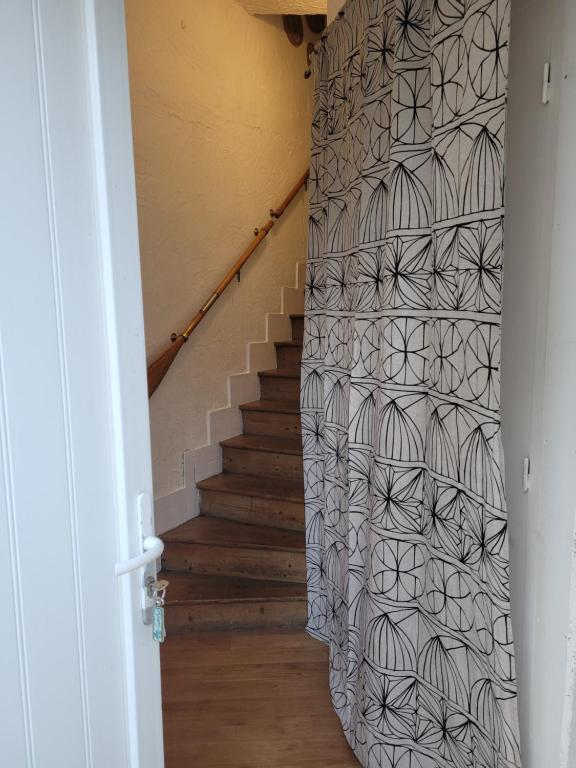 a stairway with a black and white patterned wall at LA P&#39;TITE YPORTAISE in Yport