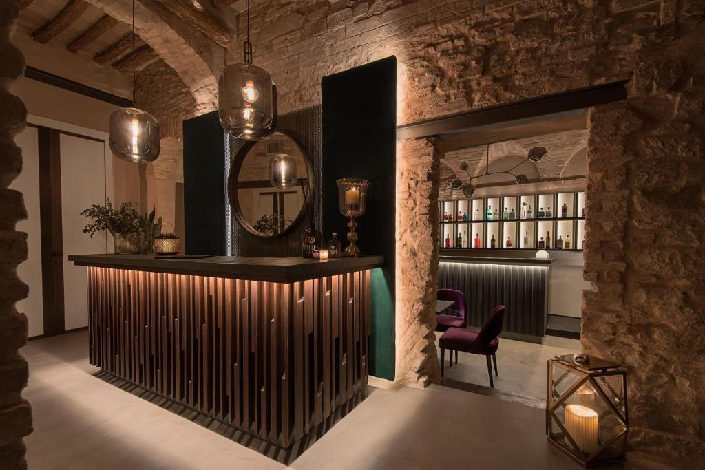 a bar with a mirror and a chair in a room at Times Suites & Bar in Perugia