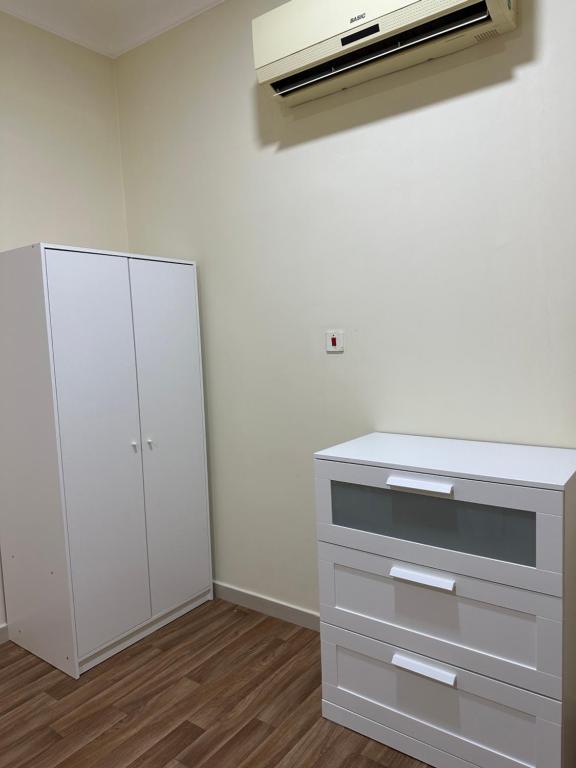 uma cozinha com um balcão branco e um armário branco em شقه بغرفة نوم تسجيل دخول ذاتي em Ar Rākah