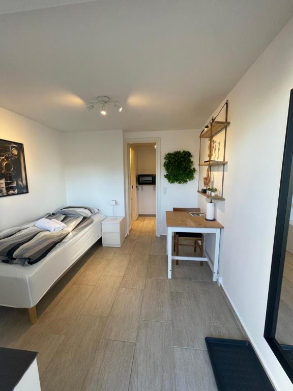 a bedroom with a bed and a table in it at City Aarhus in Aarhus