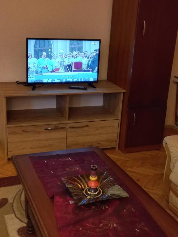 a living room with a tv and a table at Luxury Apartments Bitola in Bitola