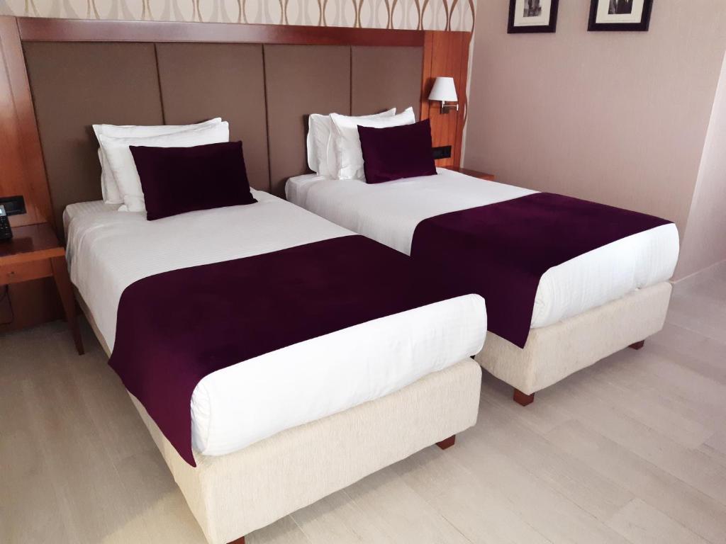 Postel nebo postele na pokoji v ubytování Xenon Hotel & SPA