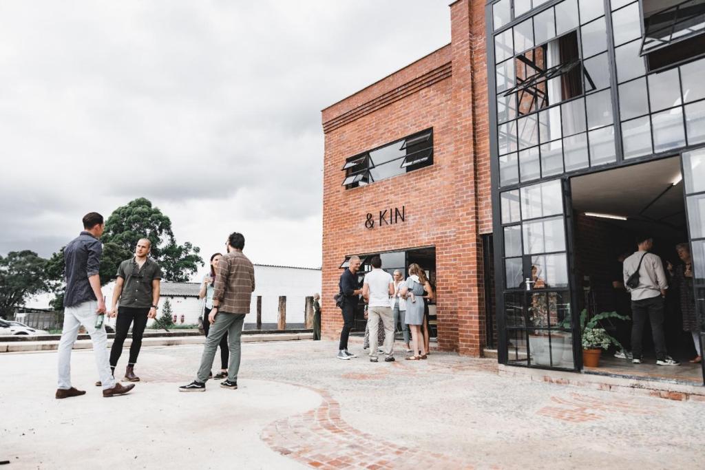 a group of people standing outside of a building at The Old Mushroom Farm in Howick