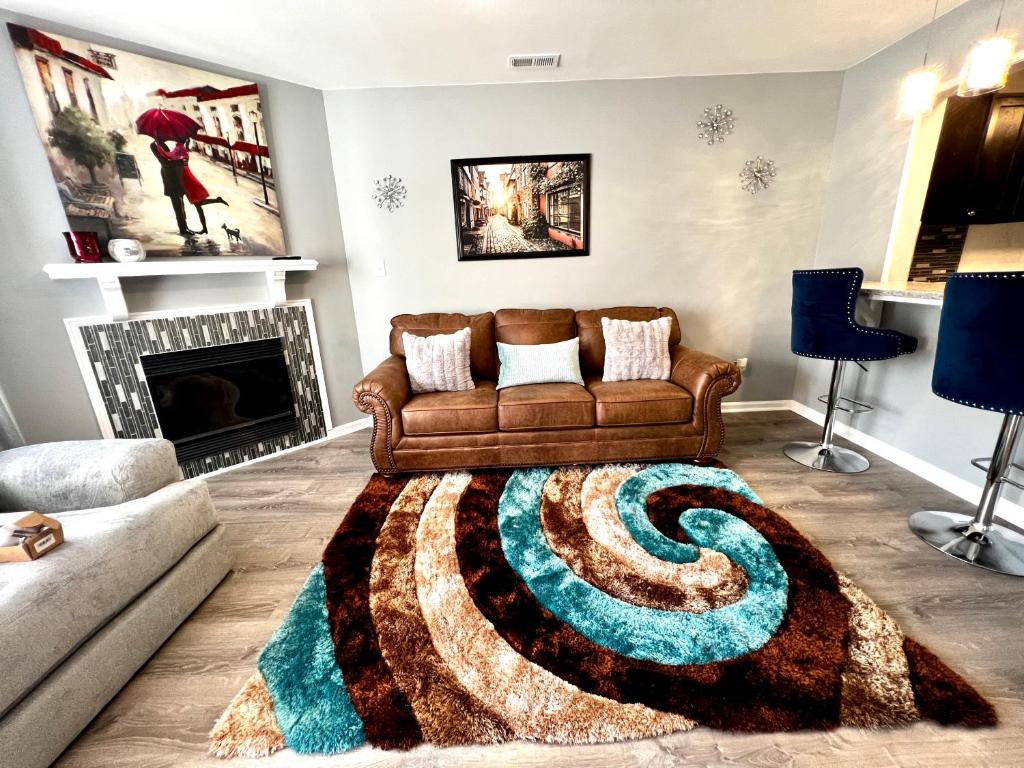 sala de estar con sofá y alfombra en Luxury Townhome Jacksonville, NC en Jacksonville