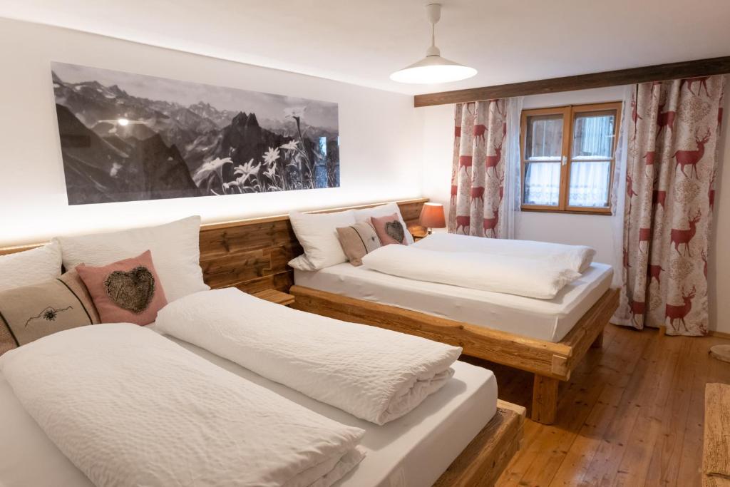 a living room with two beds and a couch at Landhaus im Allgäu in Halblech