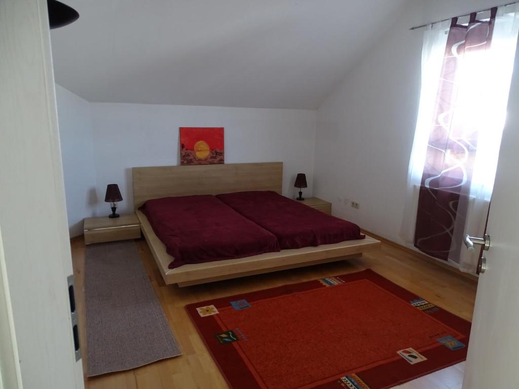 a bedroom with a bed and a window and a rug at Ferienwohnung Lottstetten in Lottstetten