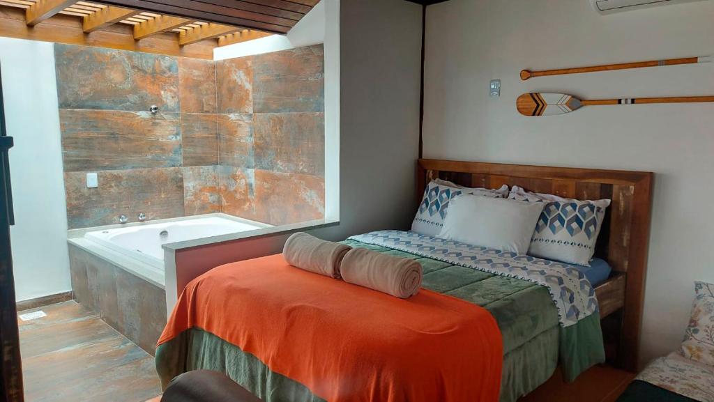 Ένα ή περισσότερα κρεβάτια σε δωμάτιο στο Pousada Águas de Ibiraquera Suíte Ribanceira