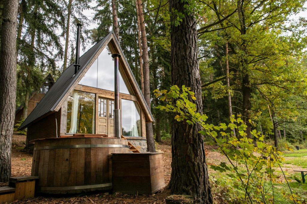 a cabin in the woods with a tree at Hygge Chalet 