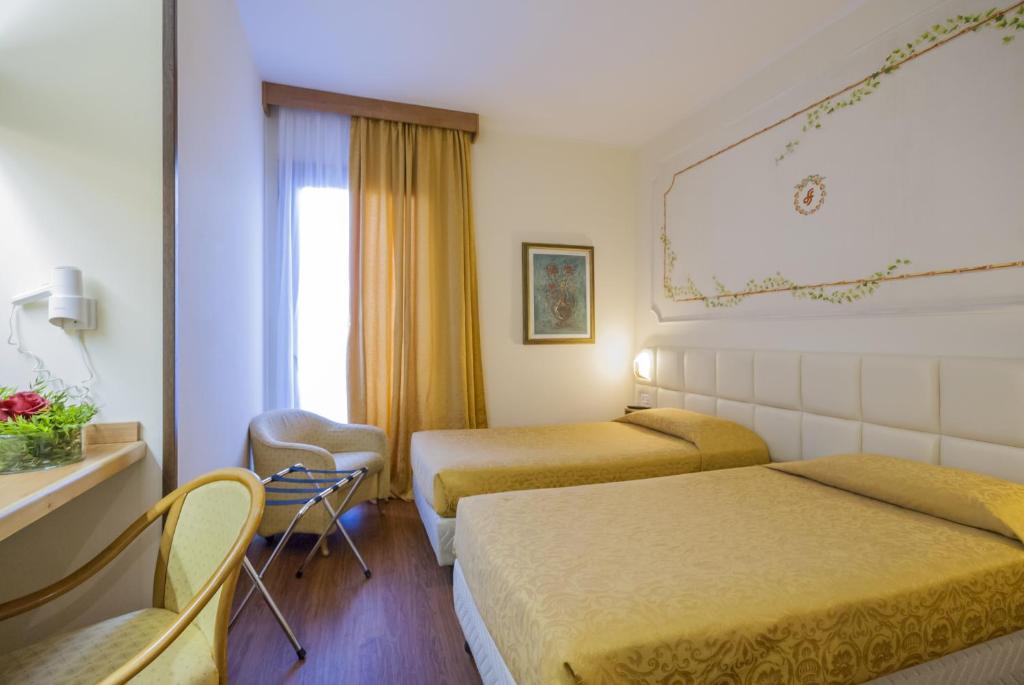 Postel nebo postele na pokoji v ubytování Hotel Delta Florence
