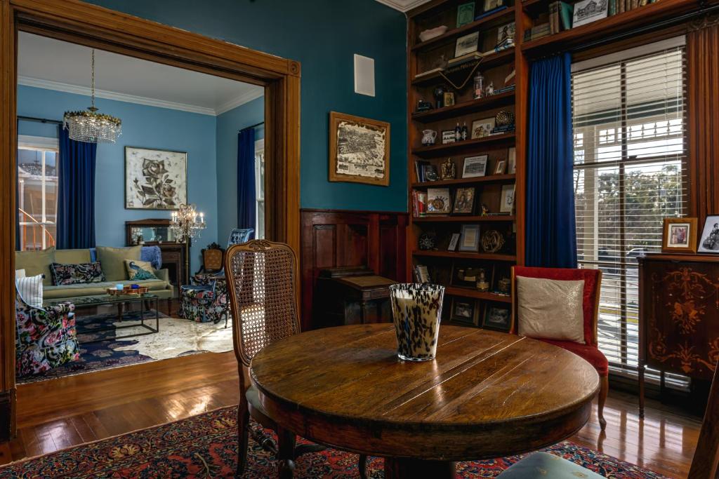 a living room with a wooden table and a couch at Celestine Bed and Breakfast in Pensacola