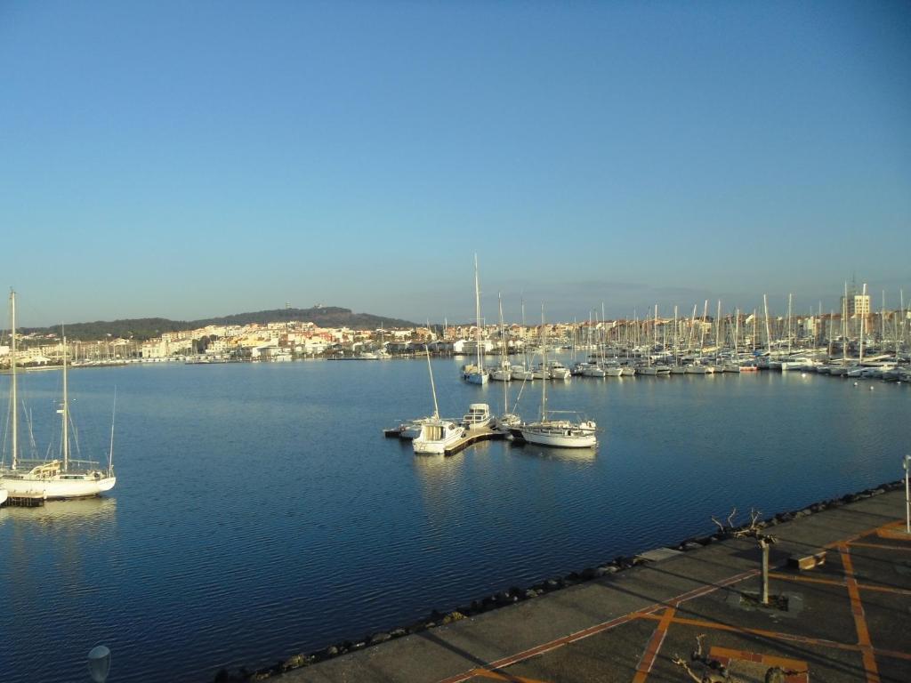 a bunch of boats are docked in a harbor at Vue Mer 180° Parking+Lave-Linge+Proche Plages+Piscine in Cap d&#39;Agde