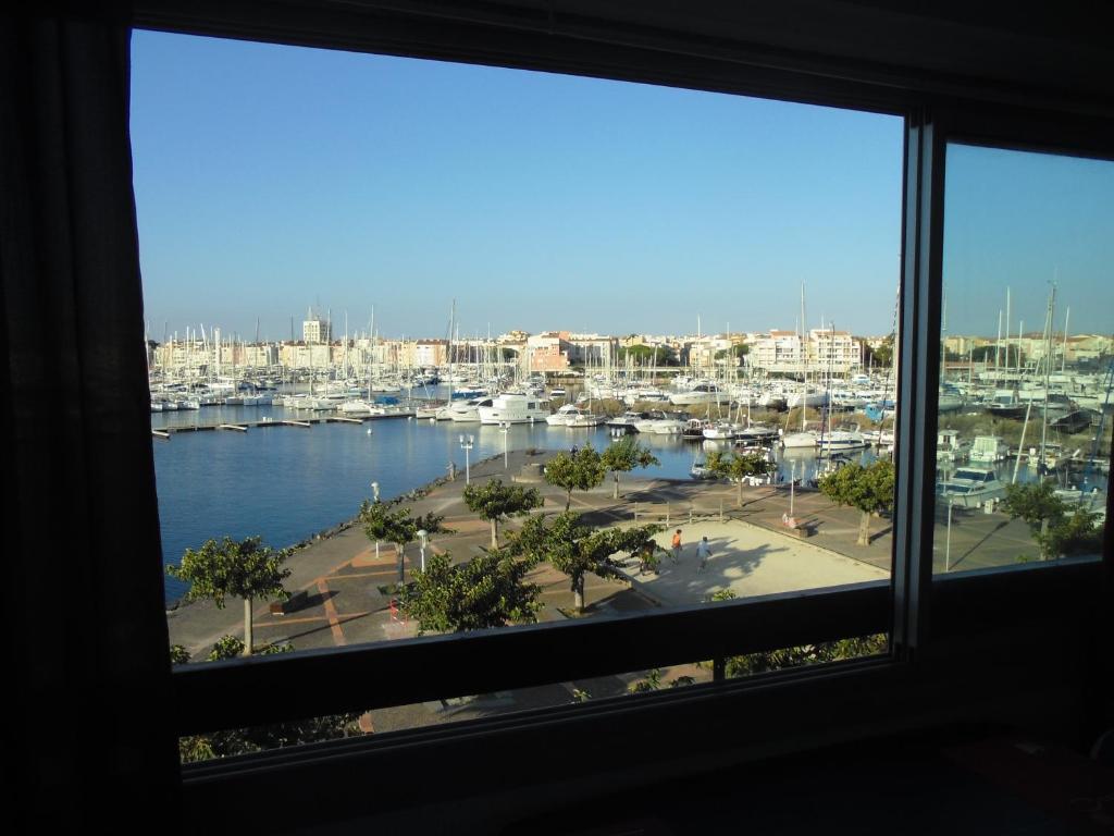 a view from a window of a marina at Vue Mer 180° Parking+Lave-Linge+Proche Plages+Piscine in Cap d&#39;Agde