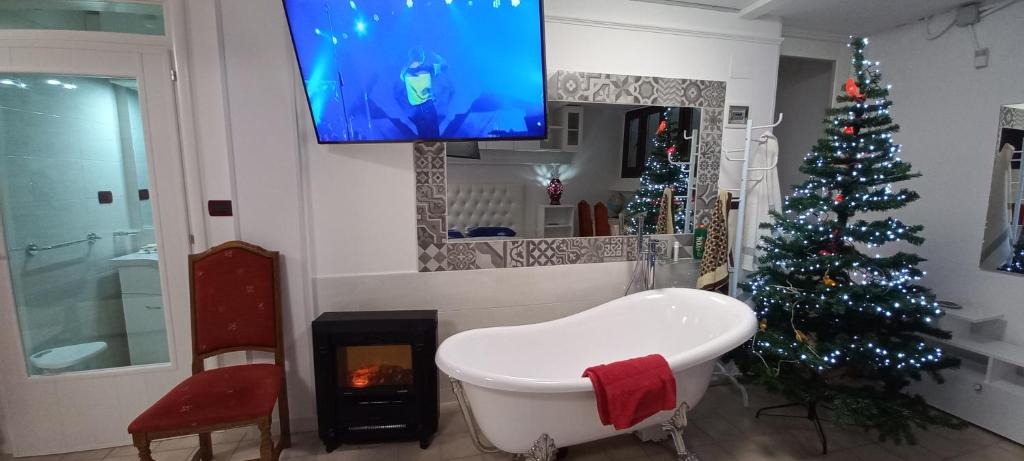 a living room with a christmas tree and a tv at Le Due Palme House in Torre San Giovanni Ugento