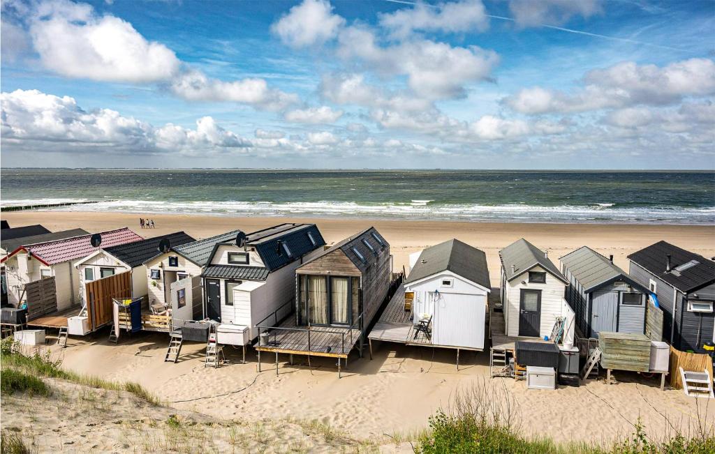 una fila de cabañas de playa en una playa de arena en 1 Bedroom Gorgeous Home In Vlissingen, en Vlissingen