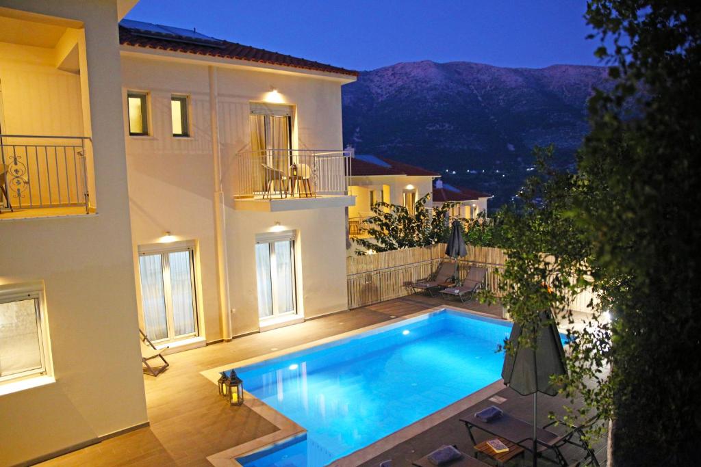 a swimming pool in the backyard of a house at Amarianos Villas in Agia Effimia