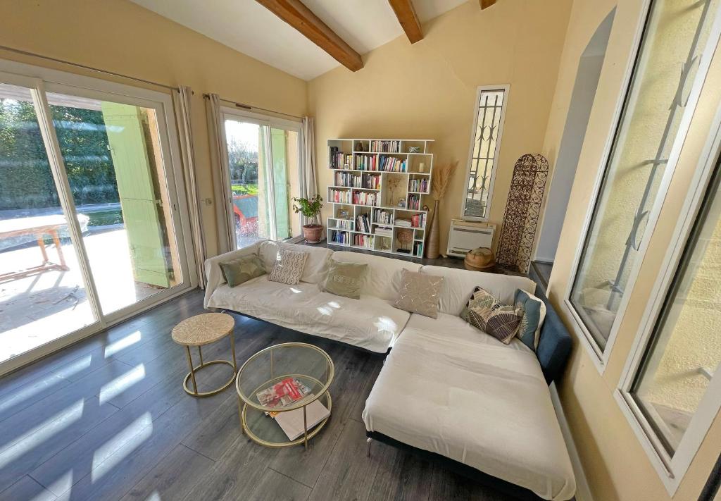 sala de estar con sofá y estante para libros en Villa d&#39;architecte avec piscine et grand jardin, en Marsella