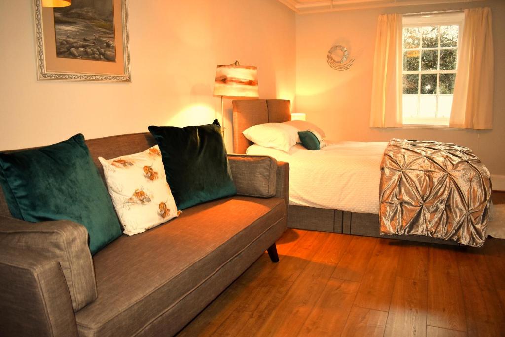 a living room with a couch and a bed at Corrie Apartment in Appin