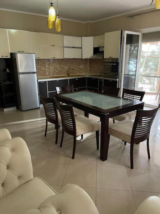 a kitchen with a table and chairs and a refrigerator at Lovely 2 bedroom unit with beach view in Golem