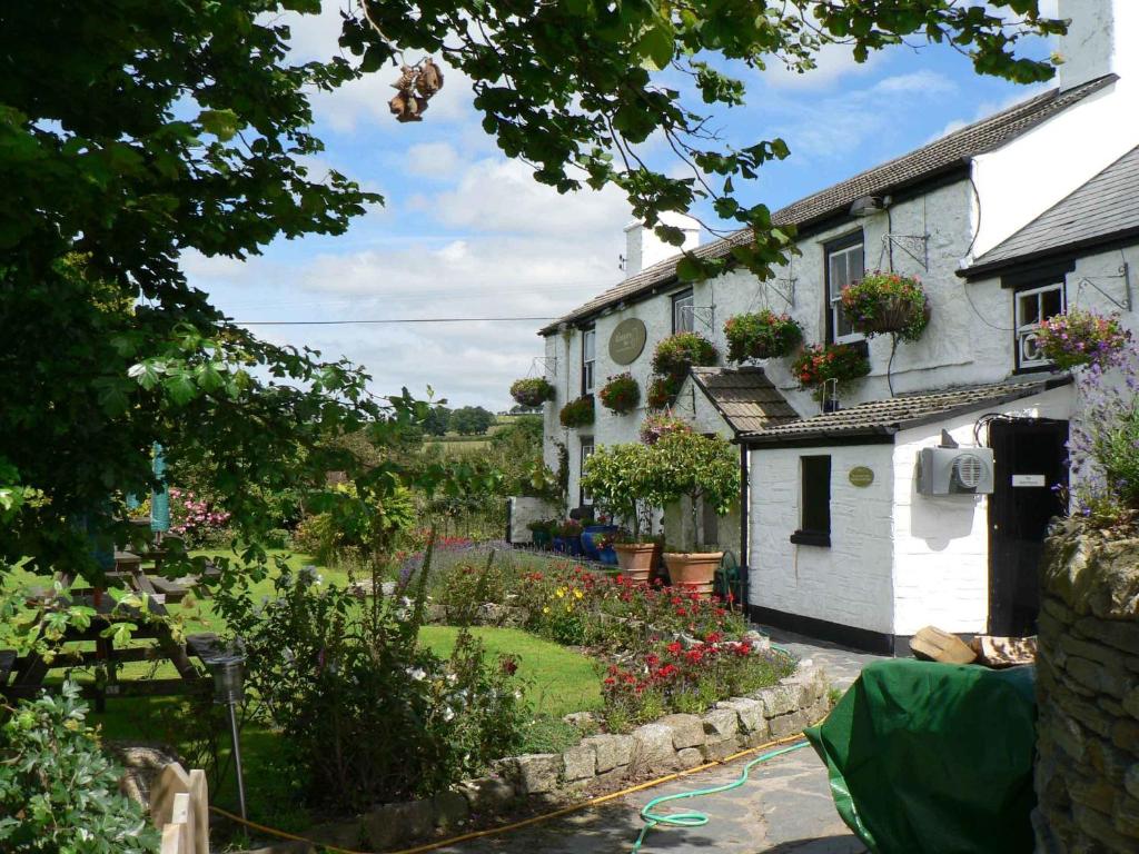 a house with a garden in front of it at The Elephants Nest Inn in Marytavy