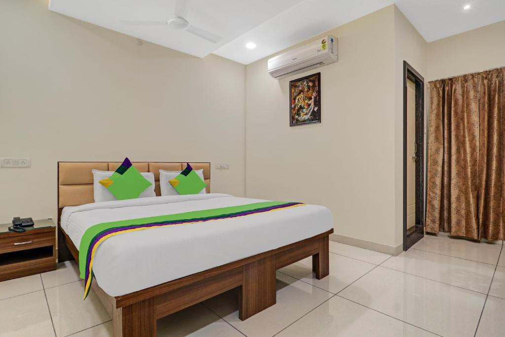 a bedroom with a bed in a room at Treebo Trend Virat Residency - US Consulate in Hyderabad