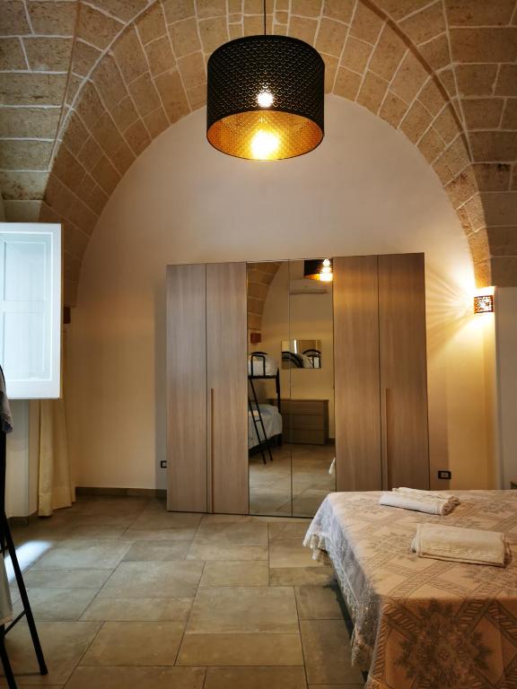 a room with a bed and a mirror at LA VECCHIA TORRE 1920 in Grottaglie
