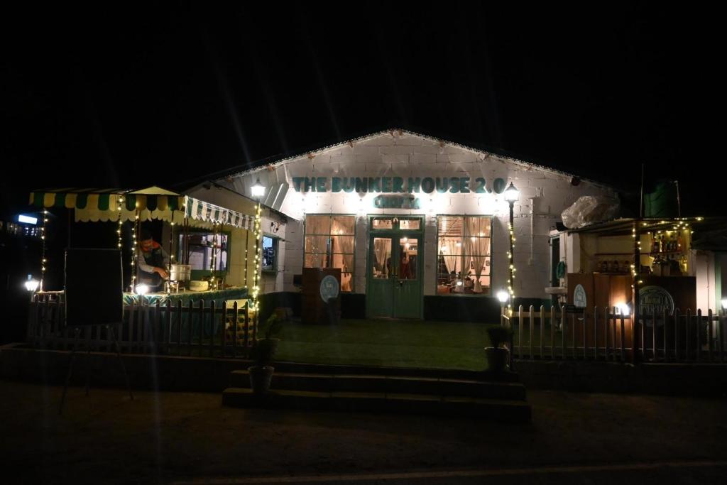 a restaurant lit up at night with lights at The Bunker House in Chopta
