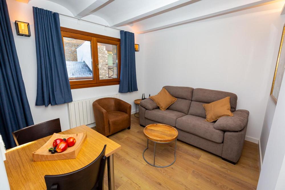 a living room with a couch and a table at Apartments TELECABINE 365 in La Massana