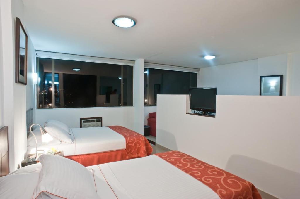 Postel nebo postele na pokoji v ubytování Hotel Dann Combeima