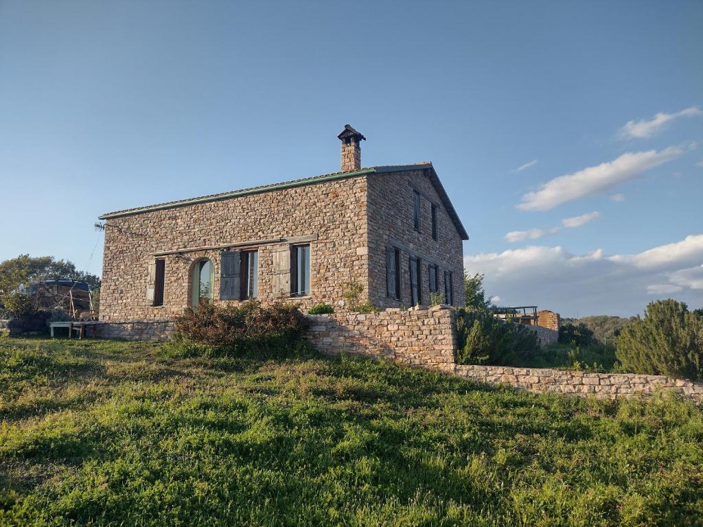an old brick building on a grassy hill at Raphale in Preveza