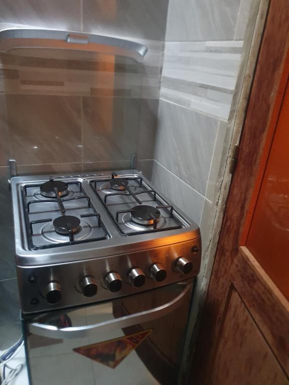 La cuisine est équipée d'un four avec plaques de cuisson. dans l'établissement Résidence Hadja 01, à Dakar