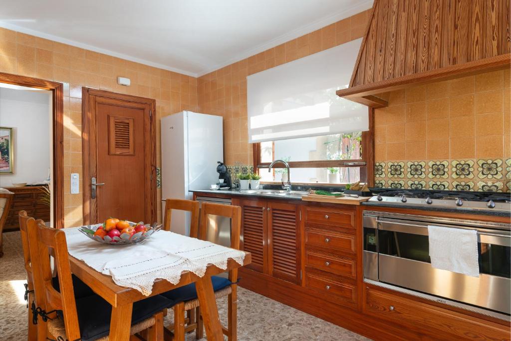 a kitchen with a table with a bowl of fruit on it at Chalet Son Gomila in the North of Mallorca in Cielo de Bonaire 